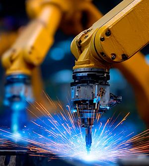 Robotic arms welding with sparks